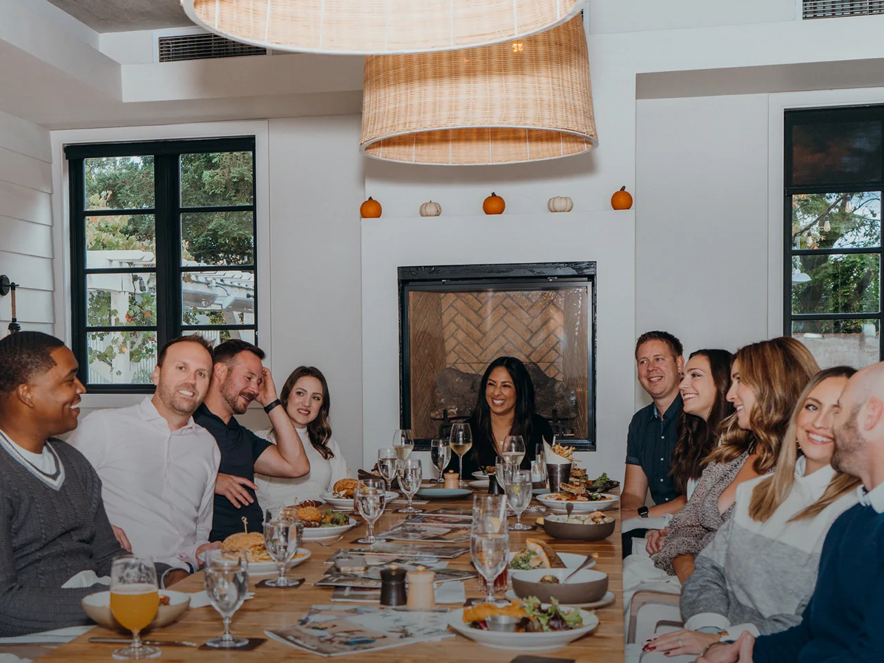 The team sharing a meal around a long table.