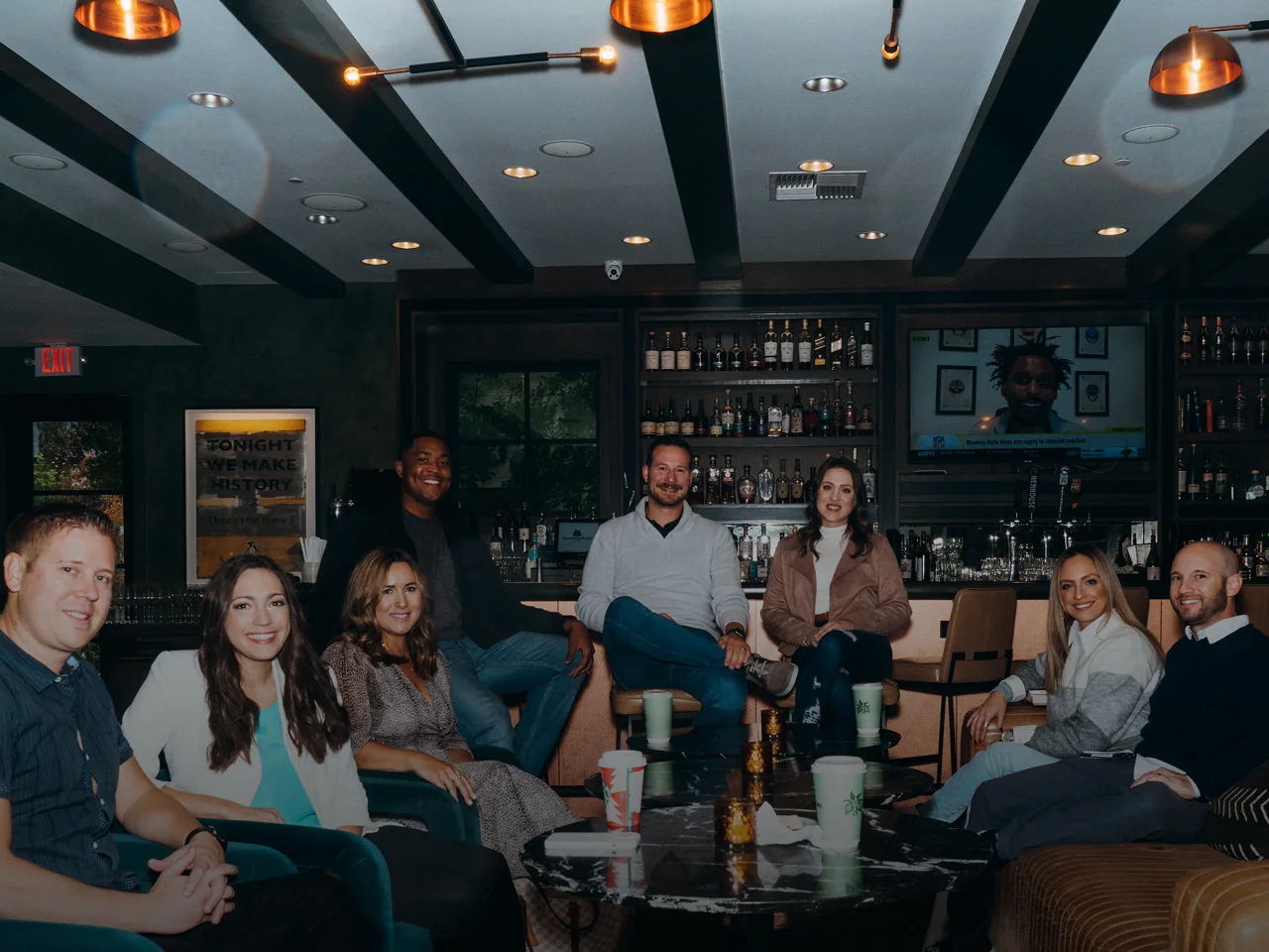 The team gathered together in a lounge.